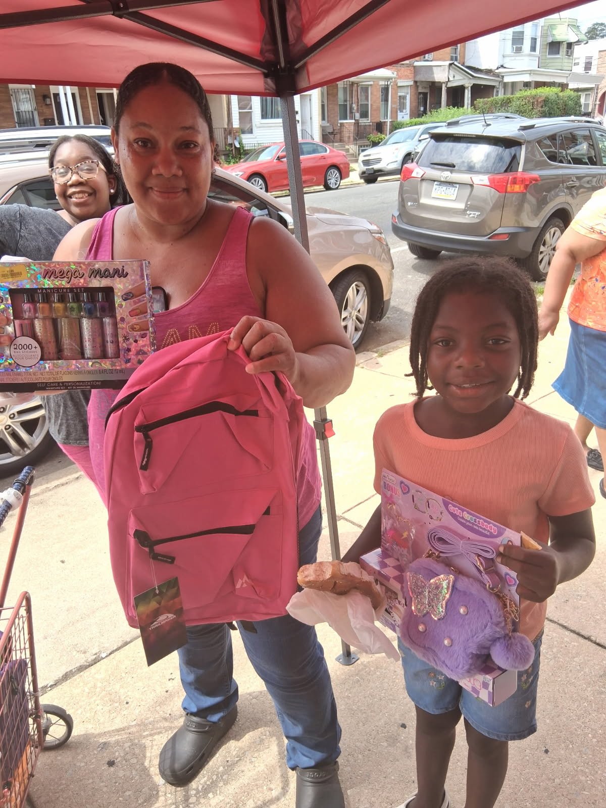 Family receiving school supplies and gifts during community outreach